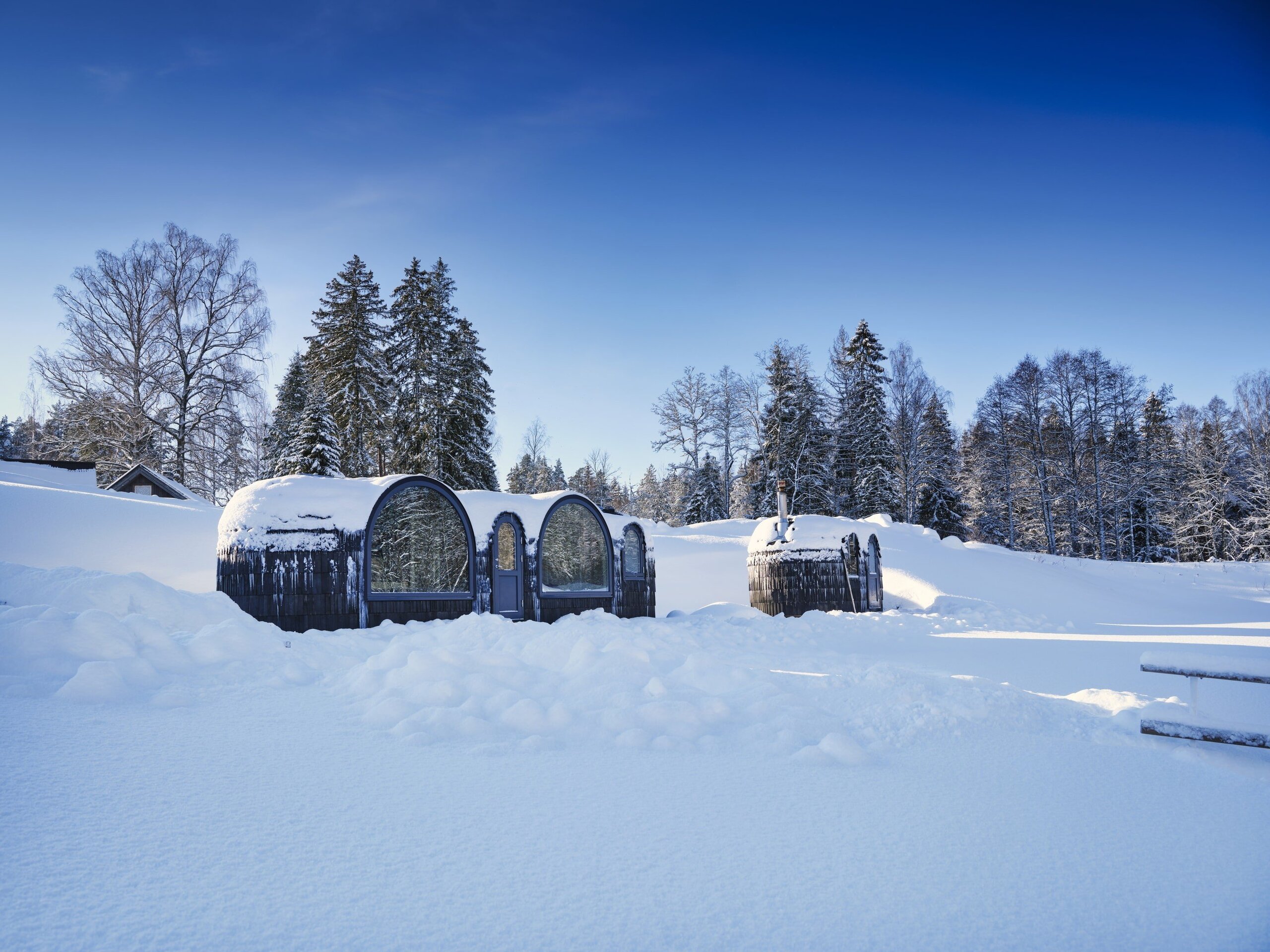 Cabin and Saunas under a blanket of snow