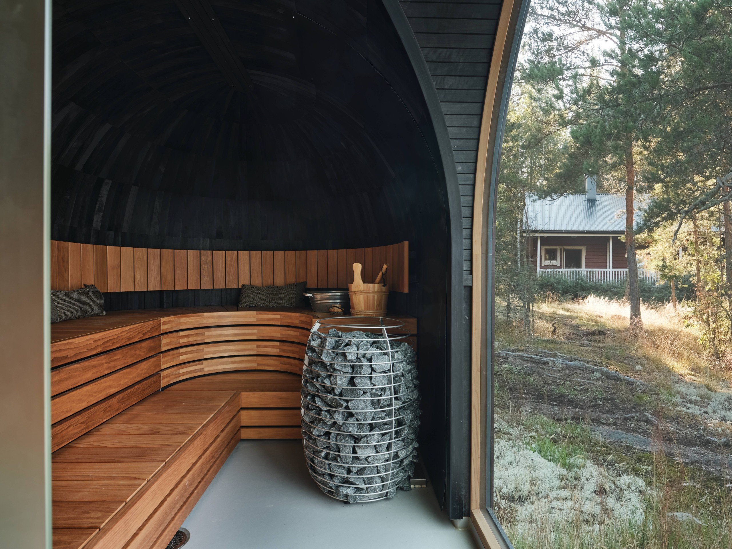 Sauna room with an electric heater and a window